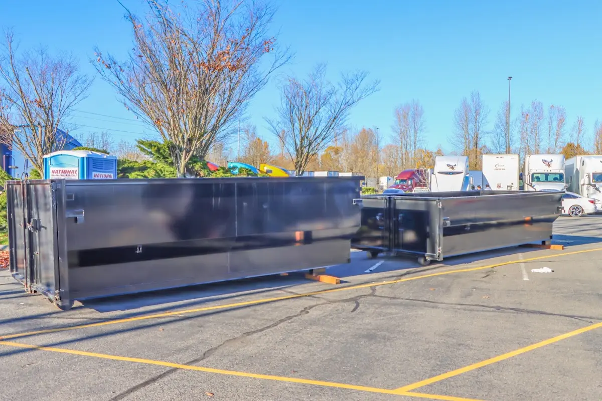 Professional dumpster rental service with roll-off container on residential driveway in Lilburn